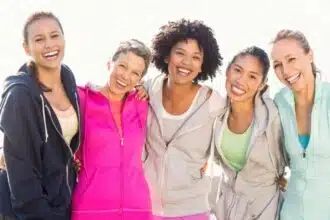 laughing sporty women with arms around each other