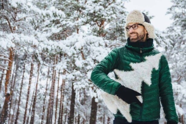 young man standing by tree during winter