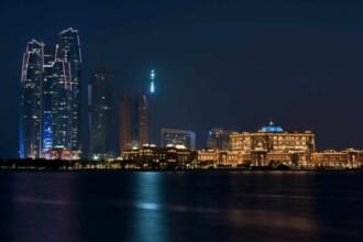 abu dhabi buildings skyline from sea night