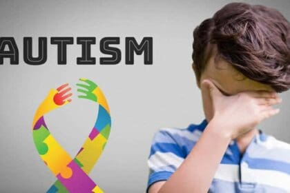 boy against grey background with autism colorful hope hands ribbon