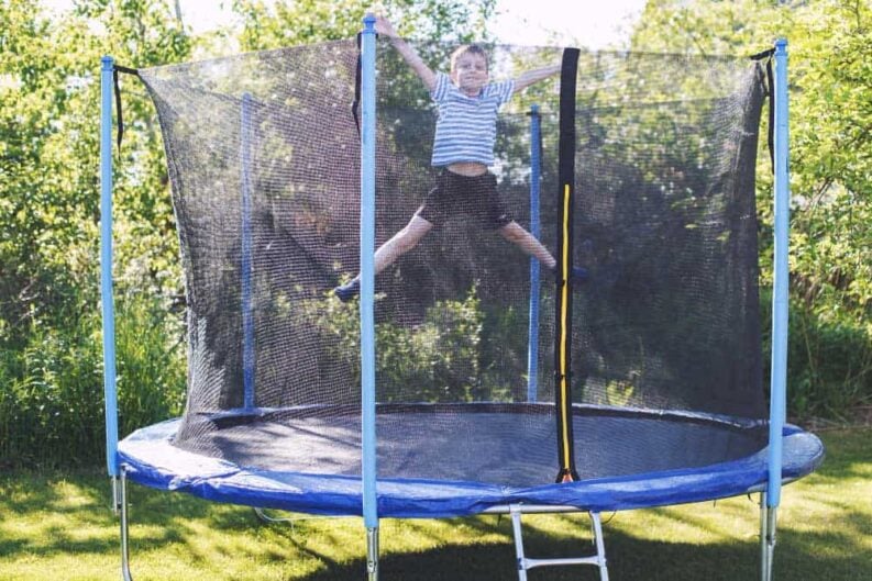 boy jumping trampoline child plays trampoline outdoor