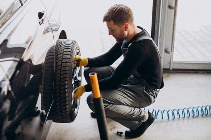 car mechanic changing wheels car