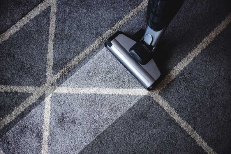 close up steam cleaner cleaning very dirty carpet