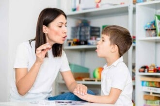 cute boy with speech therapist is taught pronounce letters words sounds