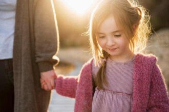 cute girl holding mother s hand