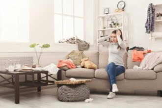 desperate woman sitting sofa messy room