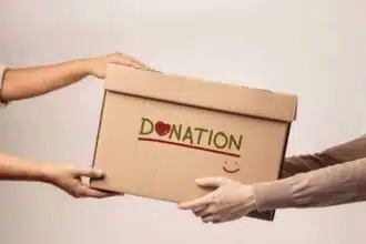 donation concept volunteer giving donate box recipient standing against walll