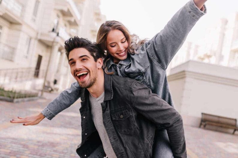 excited man black denim jacket chilling with girlfriend outdoor portrait happy couple exploring city