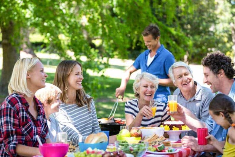 family friends having picnic with barbecue
