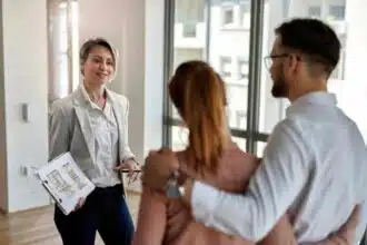 female real estate agent communicating with couple while showing them new apartment