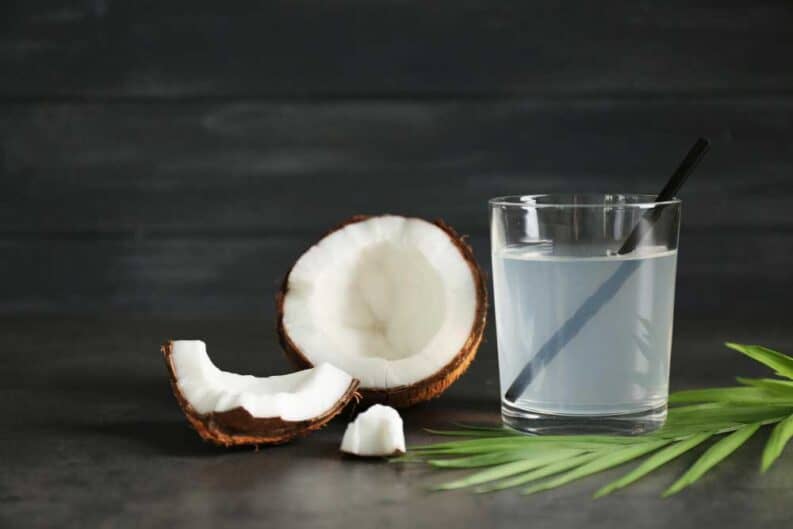 glass coconut water fresh nut dark background