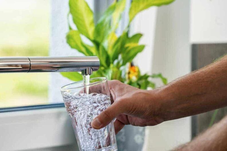 glass filled with water from faucet