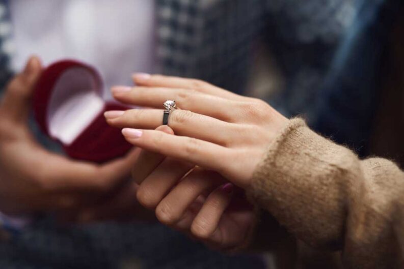 hands young couple girl wears diamond ring 1