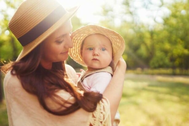 happy stylish loving family mother playing with her baby outdoor lovely baby smiles enjoys mother s day concept