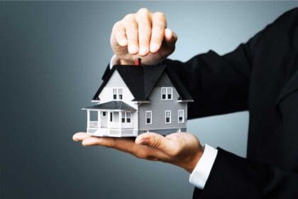 male hands holding house model background