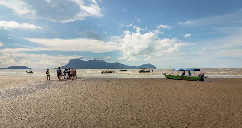 people walking beach get boats return from bako national park borneo