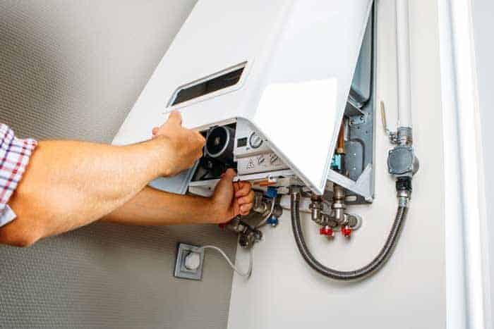 plumber attaches trying fix problem with residential heating equipment repair gas boiler 1