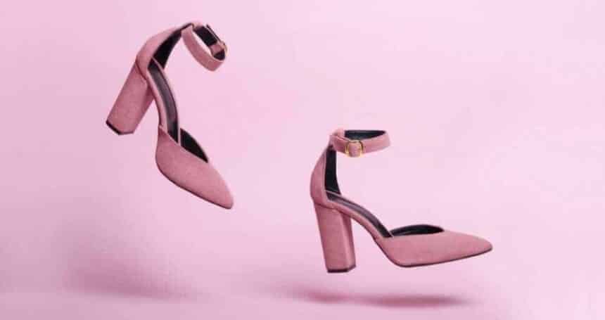 running female pink high heel shoes isolated pink background fashion shoes photo motion