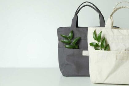 stylish eco bags with twigs white surface