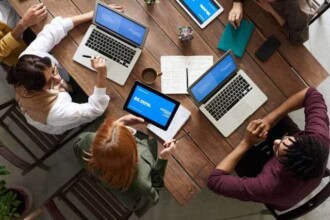 top view photo of group of people using macbook while 3182773