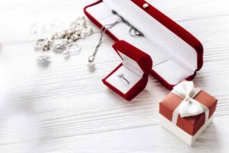 valentine day concept stylish diamond ring red present box luxury jewelry accessories white rustic wooden background greeting flat lay with space text