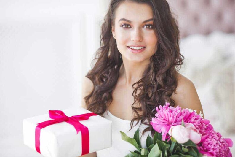 very beautiful woman with peony gift box indoors