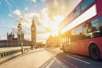 view big ben houses parliament with red bus sunset london