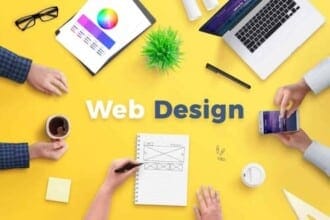 web design team work project concept yellow desk with web design text top view flat lay