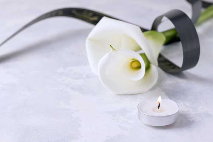white flowers with mourning ribbon