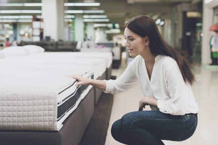 woman chooses mattress store