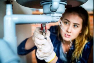 woman fixing kitchen sink