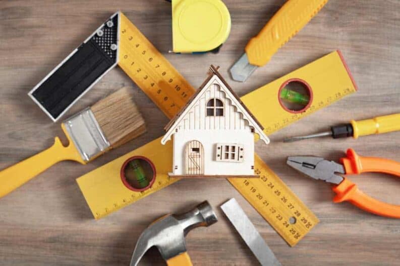 work tools with wooden house model