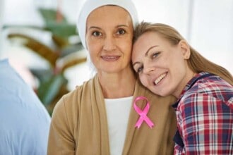 young beautiful daughter sit beside mother who fight cancer support her hospital bed