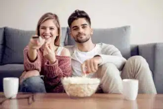 young couple watching tv sofa