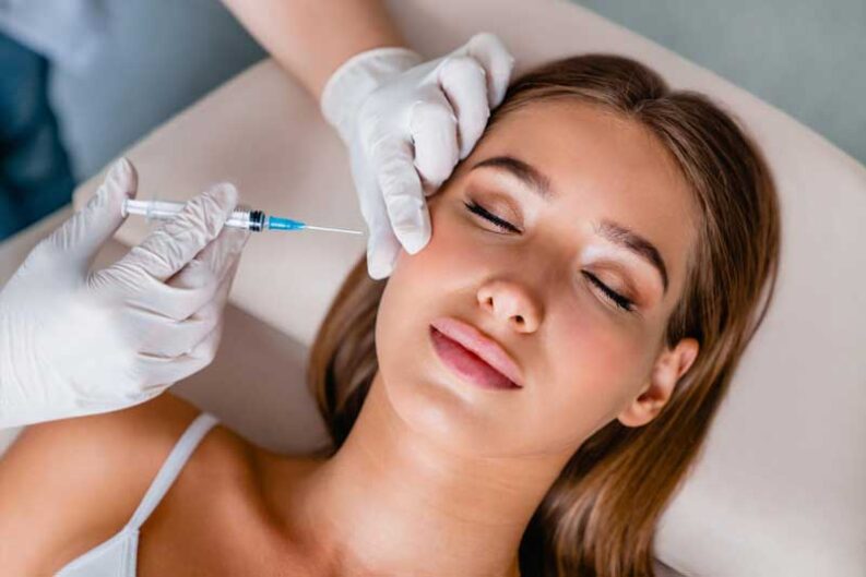 young woman gets beauty facial injections salon