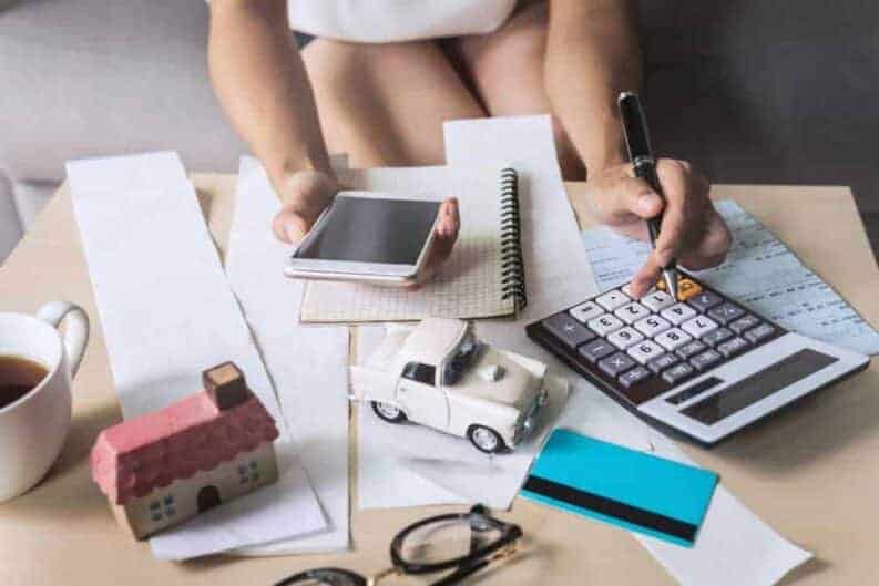 young woman using smart phone checking bills