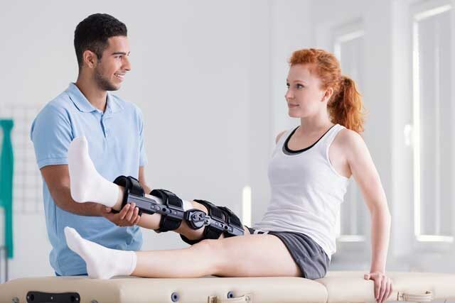 young woman wearing a brace during rehabilitation 5M9DXVK