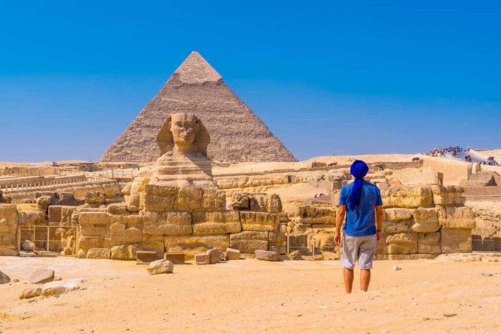 young man walking towards great sphinx giza