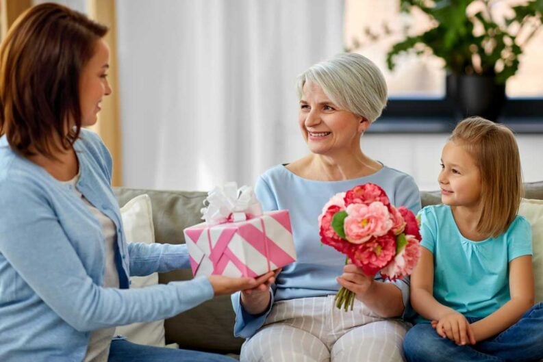 family giving present to grandmother