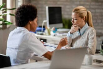 thoughtful woman going through medical test results with her doc original 1