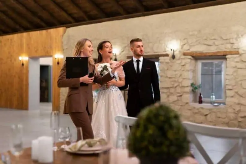 female wedding planner working with bride groom scaled