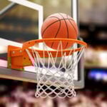 Basketball ball scoring the winning points on basketball net hoop on basketball arena.