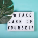 Lightbox with motivational words for self-care, mental health, emotional well-being. Top view.